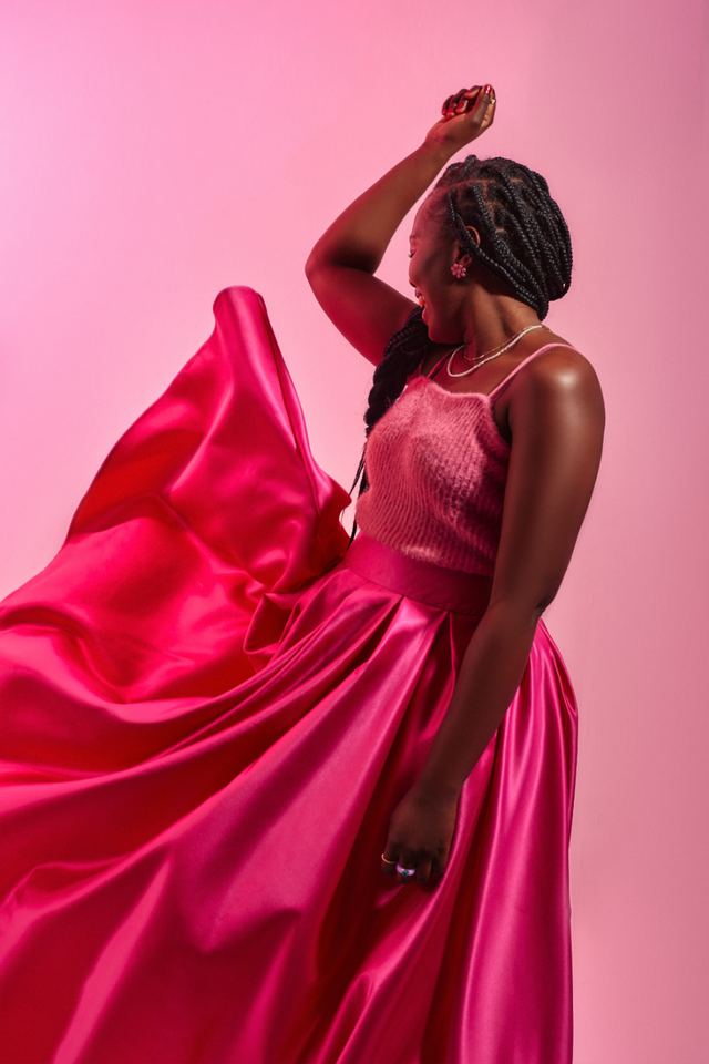 Model in a pink satin skirt against a pink backdrop, My Colour Campaign