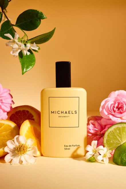 Michaels Bouquet eau de parfum with citrus, roses and jasmine on a warm yellow set