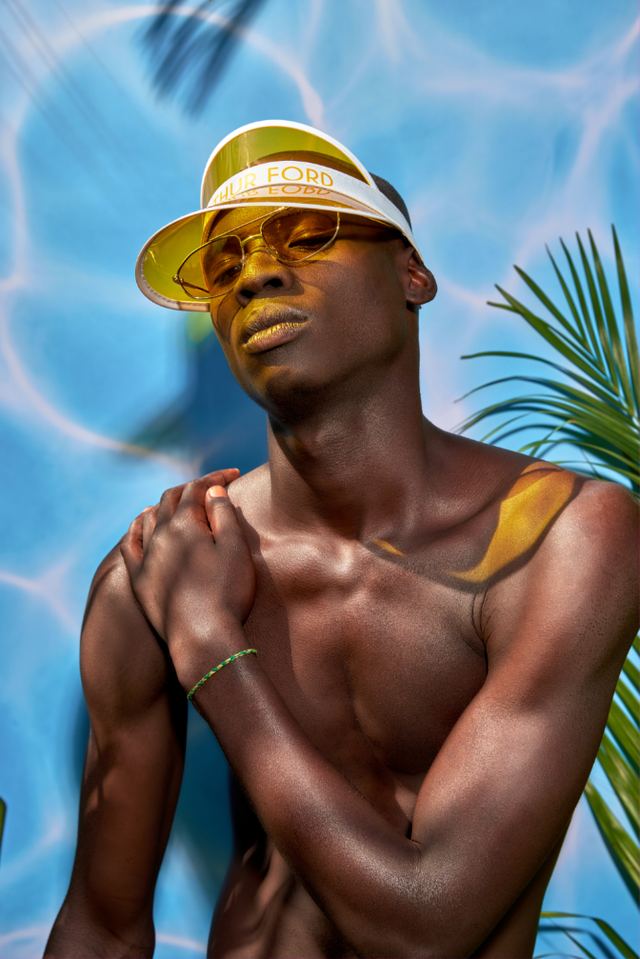 Model in a gold visor against painted pool water, Exotic Desire campaign