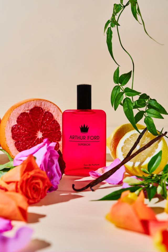 Pink Arthur Ford bottle styled with grapefruit, roses and vanilla